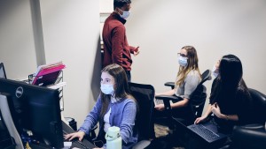 Rosalind Franklin University students volunteering at the front desk of the Interprofessional Community Clinic.