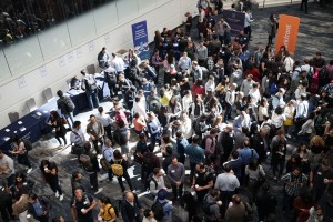 Overhead view of a bustling conference with diverse attendees mingling, sharing ideas, and networking.