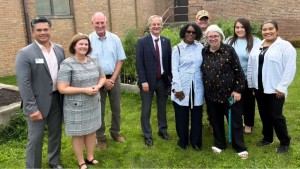 Aron with the team visiting the Healing Garden. From left: Jeff Espina, Shelly Bryzcki, Bob Jackson, Aron Sousa, Senator Adriane Johnson, Jeremy Couch, Ellen Ewing, Mayra Trujillo, and Jocelyn Rodriguez. 