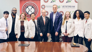 President Sousa and John Shufeldt, MD ’86 (center), with RFU students. Students, from left: Noel Vincent (CMS), Agbai Kalu (CMS), Lira Zajmi (COP), Japani Doan (COP), Ingrid Frayer (SCPM), Shelby Hicks (CMS), and Richard Moraga (CMS).