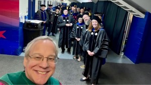 Aron behind the scenes with the stage party before commencement 2026.