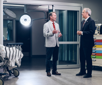 Aron joins Interim Provost Dr. James Carlson (left) in the new RFU Virtual Health System.