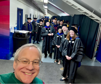 Aron behind the scenes with the stage party before commencement 2026.