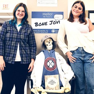 Two students standing next to a skeletal model in the Boxer Library