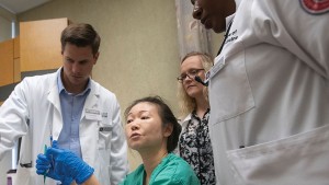 Stephanie Wu, DPM, MSc, FACFAS, joins podiatry students during a Thursday night clinic at the North Chicago facility.